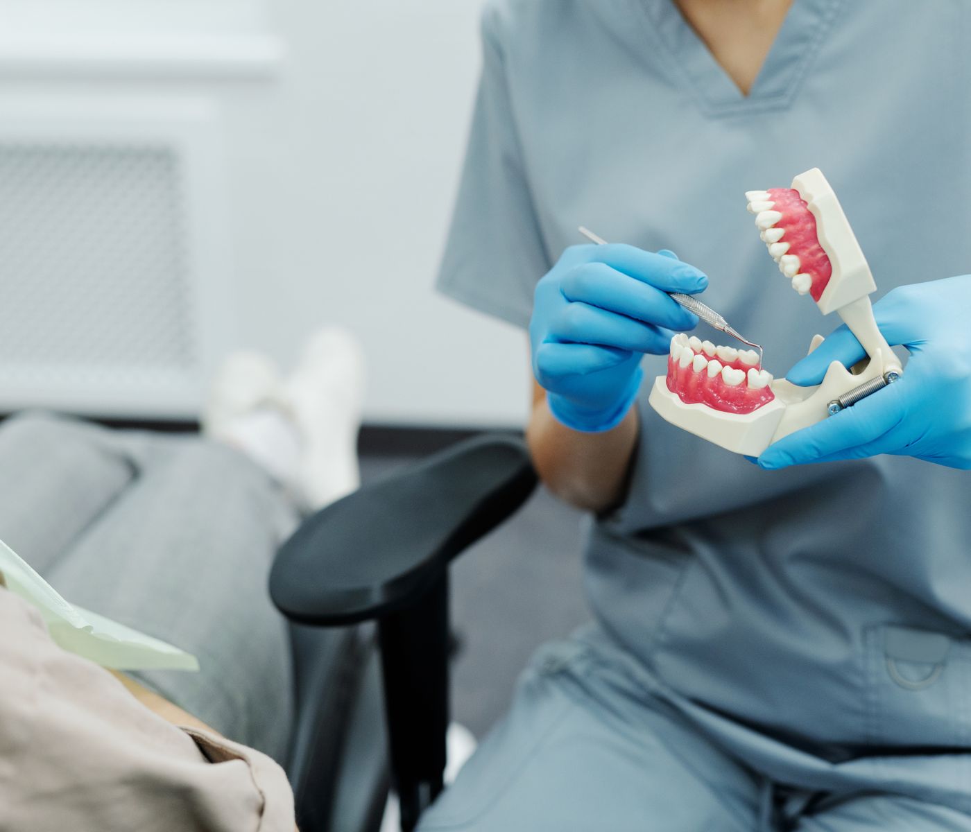 Dental professional explaining a tooth model